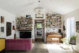 Polished concrete floors continue into a living room/library with vaulted ceilings.