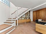 &nbsp;A wooden staircase leads to the ground level, which holds three bedrooms, two baths, a game room, and a wine cellar.