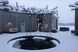 The circular main building has an open-air plunge pool at its center.