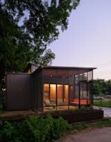 Situated behind a 1940s house in an East Austin alley, this ADU used as a primary residence marks the first of its kind to be featured in the AIA Austin Homes Tour. Tall ceilings and clerestory windows make the 758-square-foot interior feel spacious. Glass doors connect the living room to a 159-square-foot screened porch.