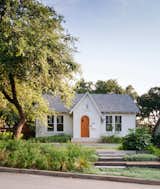 Once a derelict 1930s cottage, this renovated home in the heart of Austin conceals a metal-roofed addition that holds a glass-walled, cantilevered living space with a 28-foot concrete bench overlooking the rear garden, as well as a screened porch. The asymmetric gabled roof at the entry hints at the eccentric elements inside: there are wood details throughout, such as sinker cypress sills and ledges made from logs reclaimed in rivers and swamps.&nbsp;