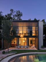 A central courtyard awaits inside this newly constructed home south of downtown Austin. The exterior’s board-formed concrete, steel, and stucco elements complement the warm walnut, industrial steel, and smooth plaster within. A two-story dining porch with a steel louvered screen offsets the home’s southern exposure and provides privacy for the upper-level bedrooms.&nbsp;