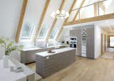 The home’s kitchen is bright and airy, thanks to three large skylights which flank the wall. "Creating a home that is all roof requires a rethinking of all your windows," says Georgina. "Skylights became key to getting daylight and the surrounding view visible in every room."