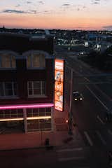 Bright LED sign advertising Horse Palace Casino hangs from corner of brick building at dusk in Cheyenne, Wyoming.