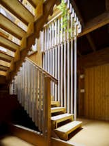 A skylit staircase, wrapped in a more refined version of the exterior slats, rises through the center of the 1,600-square-foot house.