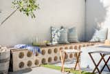 The Concrete Collaborative Trestles Circle Breeze Blocks in Beige add an elevated architectural pattern to a simple block bench capped with natural wood.&nbsp;