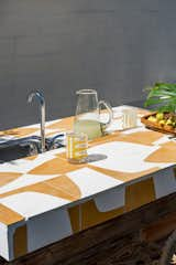 The Strands x Dwell collection by Concrete Collaborative is inspired by Californian surf culture and the tiles are available in a range of bold, midcentury-inspired colors—such as the Acacia color specified on the outdoor bar.