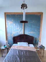 The bedroom, featuring the antique bed and the custom wall covering behind it. 