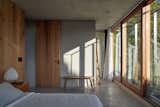 Most of the color in the primary suite comes from the greenery right outside.
