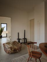 A found boulder sits beside chairs by artist Samuel Richard Hess.