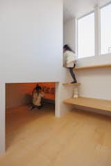 On the top level, a cozy cubby serves as yet another play nook for the girls, with a large closet above it that, in the future, can be converted into a bedroom with the addition of a curtain.