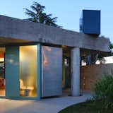 A whimsical navy blue water tank balances on the edge of the roof.  Photo 10 of 11 in Pops of Color and a Concrete Cube Make This Argentina Retreat Like “a Ball Pit for Grown-Ups”