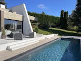 The home’s living area opens to a long, sparkling pool in the backyard.