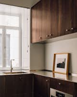 Pine is utilized throughout the home, however the kitchen cabinetry is treated with a darker stain.