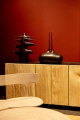 Sculptures by Watts sat atop a credenza with rough-hewn doors.