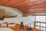 The lofted upper level features a bedroom, an en suite bathroom, and an office.
