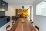 The second floor has an open-plan living and dining area integrated with a single-row kitchen. To the right of the “parlor” is a new addition with rows of skylights.