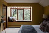 A reading nook with curved overhead windows juts out from the bedroom.