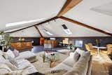 The renovated attic includes a living area and a bathroom on the floor.