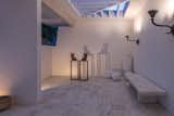 Carrara marble runs from the courtyard, through the interior spaces, and out to the pool.