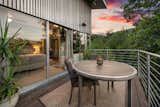 A balcony off the primary bedroom connects to the backyard with a spiral staircase.