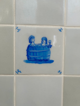 The couple worked with Regts, one of the oldest delft tile dealers in the world, to create a mix of tile for their bathroom. “We had an artist recreate paintings on the square tiles reflective of our queer life,” Jordana adds.