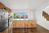 The property is a duplex that has been split into three units: a two-bedroom, two-bathroom flat on the lower level; a one-bedroom, two-bathroom apartment in the middle; and a one-bedroom, two-bathroom penthouse on top.