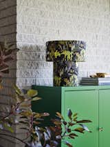 The linen-covered lamp also comes in a warm yellow. It’s set on top a new acrylic painted cabinet.