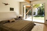 Several bedrooms open directly to the home’s tranquil backyard.