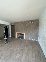 Before: The basement functioned as a family room, and was similarly covered in the cheap-feeling finishes found upstairs.  Photo 17 of 23 in Before & After: An L.A. Music Producer’s Latest Collab? Turning a Midcentury Into His Family Home