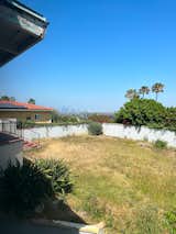 Before: The backyard was overgrown and lacked functional space for gathering, but Dahi appreciated the downtown L.A. views.  Photo 21 of 23 in Before & After: An L.A. Music Producer’s Latest Collab? Turning a Midcentury Into His Family Home