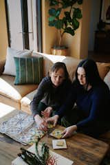 Homeowner Michelle and her daughter Kelly discussing the hand-painted tiles used in the primary en suite. Michelle cut up drawings of the tiles and glued them to brown paper to see what they would look like once set.