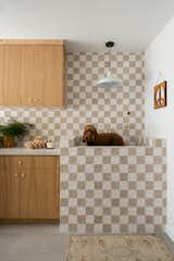 For a couple with three young sons and a dog living in Canyon Lake, California, Popix Designs founder Lizzie Green laid out a grid of ceramic tiles in a checkered pattern that matches the home renovation’s playful ’70s vibe.