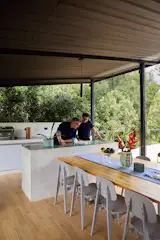 The rooftop terrace has a kitchen and dining area with a table topped in pine wood finished by Manny’s father.