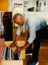 Charles selects a record from the couple’s collection.