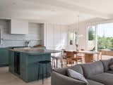 A view into the open living space, where the large windows allow for abundant natural light.  Photo 2 of 5 in How They Pulled It Off: A Built-in Tiled Bench That Honors the View
