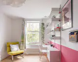 The renovation transformed the front primary bedroom into two spacious kids’ rooms. Both rooms feature Vitsoe Dieter Rams shelving units (£3.5K).