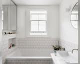Designed with function in mind, the family bathroom features classic white tiles that keep the space bright and easy to maintain, all for a budget-friendly price of £3.5K.