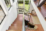 A koi pond sits at the base of the stairs to the main floor.