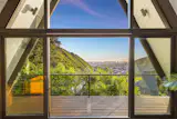 The home is perched high above Honolulu in Manoa, overlooking city skyline and ocean.