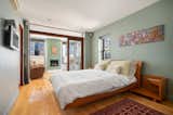 The open floor plan and sliding glass door allows natural light to flow from the living room to the bedroom.