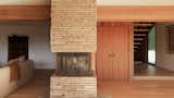A sandstone fireplace heats the living room.