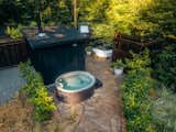 The private outdoor spa includes a hot tub, wood-burning sauna, claw foot tub, and shower.