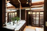 In the primary bathroom, a sunken bathtub sits below a skylight.