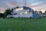 The home has a two-car garage and a wraparound deck.