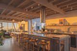 The open kitchen is the home’s heart—and its literal center, designed so the couple can host casual gatherings with friends and family. Iragüen Viñuela chose light gray granite countertops, and matching engineered wood cabinets.