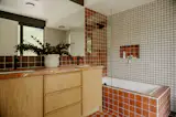 The bathrooms are finished with custom cabinetry and punchy tile.