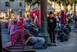 Protesters in Los Angeles seek shelter from police behind a makeshift barricade in front of City Hall.