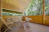 The home offers plenty of opportunities to soak up the surrounding forrest, including this covered deck.