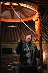 Naraa opens a roof vent to let out steam from the stove. “For twenty-five years we have lived only in gers, no matter the season,” he says. “I will continue living in the ger as long as I can.... That way we can keep up the tradition of our ancestors.”